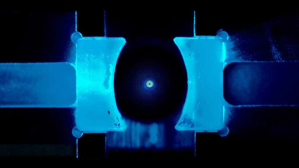 Scientists cooled a nanoparticle in a specially designed cavity (shown), reaching the lowest temperature permitted by quantum mechanics. Laser light scattering off of the nanoparticle appears as a dot in the center of this artificially colored image.KAHAN DARE, LORENZO MAGRINI AND YURIY COROLI/UNIVERSITY OF VIENNA